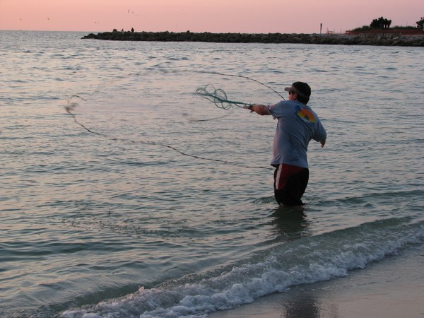 Cast netting for bait in Blind Pass. Sanibel Island.