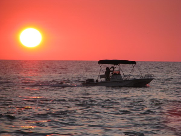 Sunset and fishing boat, Sanibel Island, Florida.