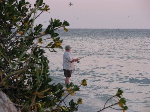 Fishing on Blind Pass beach, Sanibel Island, Florida.